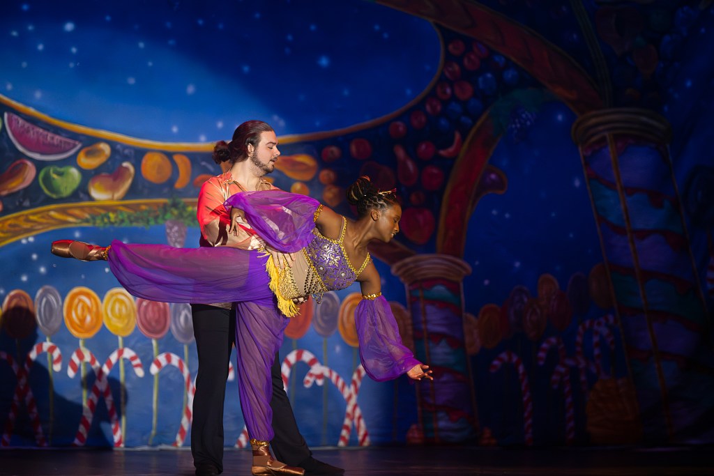 Dancers in costume onstage performing a scene from The Nutcracker ballet