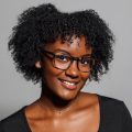 A smiling Black woman with glasses