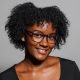 A smiling Black woman with glasses