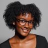 A smiling Black woman with glasses